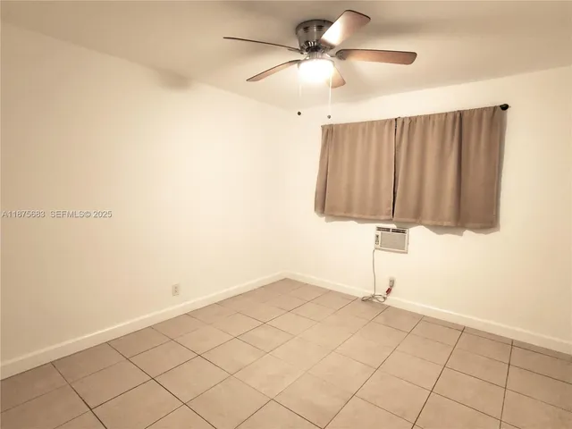 a view of a room with window and ceiling fan