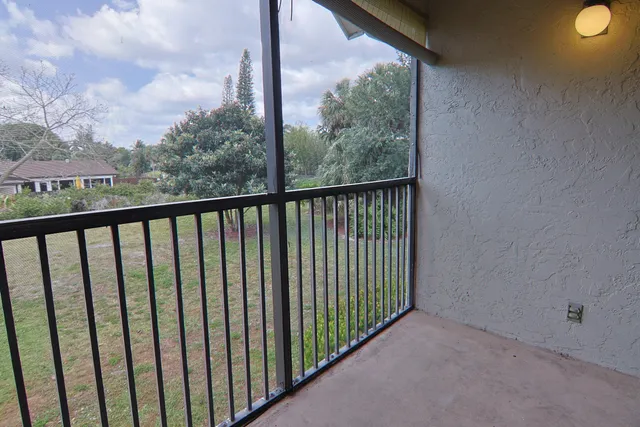 a view of a lake with a yard and trees