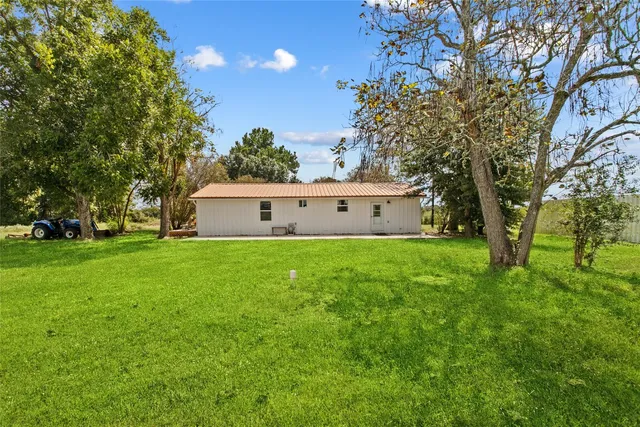 a view of house with backyard
