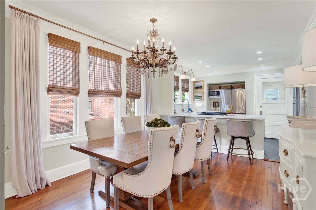 208 East 48th Street Savannah, GA 31405 - Photo 11 of 50 Dining room with custom shades, chandeler and original floors.