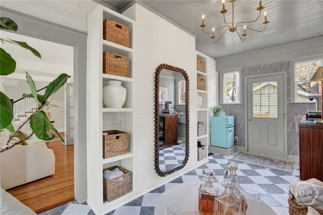 208 East 48th Street Savannah, GA 31405 - Photo 10 of 50 Coffee/bar area with ship lap ceiling, custom wallpaper, bookcases, and beautiful flooring. Door leads outside to new deck.
