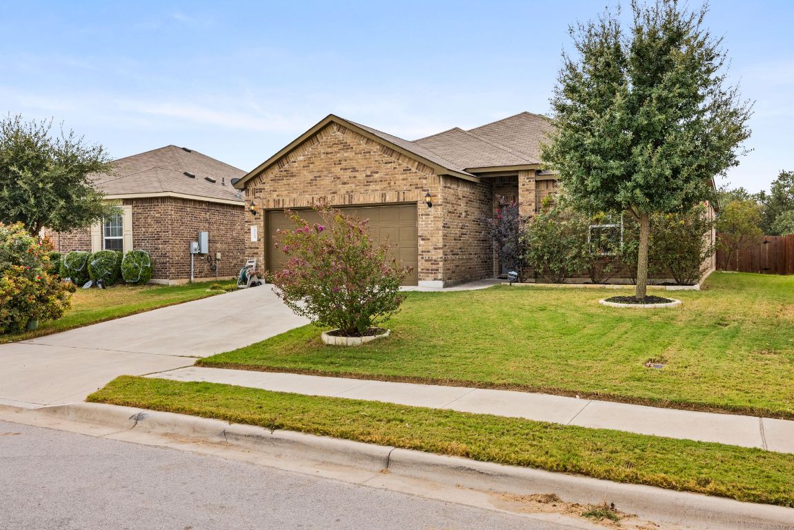 125 Hopen Cove Leander, TX 78641 - Photo 2 of 20 a front view of a house with garden