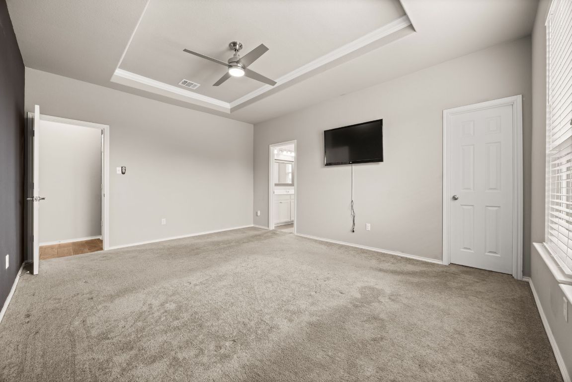 125 Hopen Cove Leander, TX 78641 - Photo 10 of 20 en empty room with ceiling fan and window