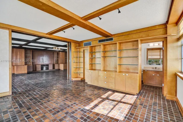 a dining room with furniture and floor to ceiling windows