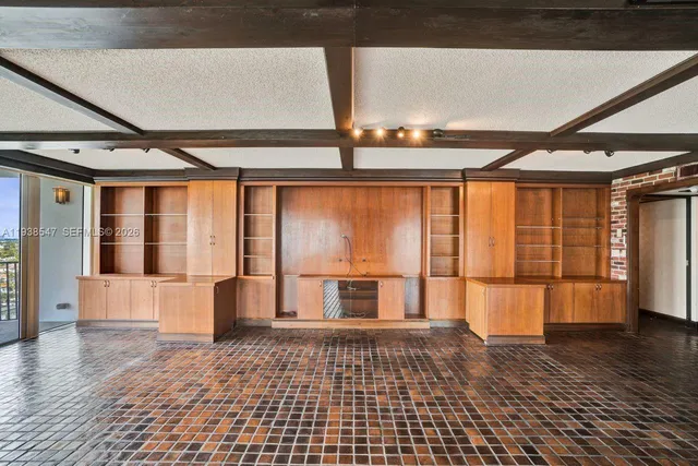 a bedroom with a bed and large windows