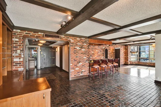 a spacious bedroom with a bed and a large window