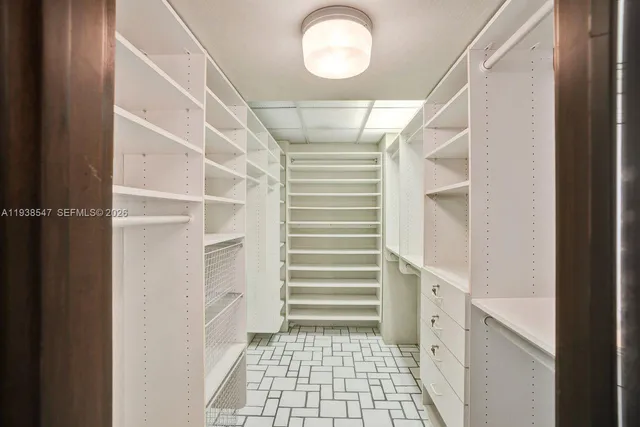 a view of a patio with table and chairs and a barbeque with potted plants
