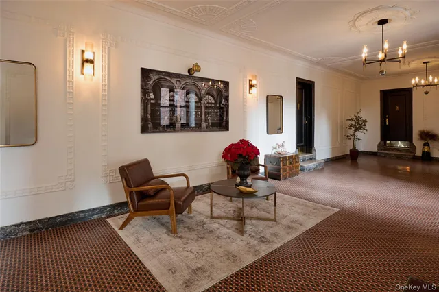 a living room with furniture a dining table and paintings on the wall