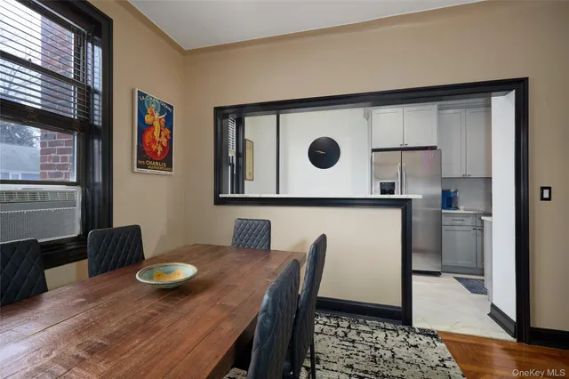 a kitchen with a table chairs and refrigerator
