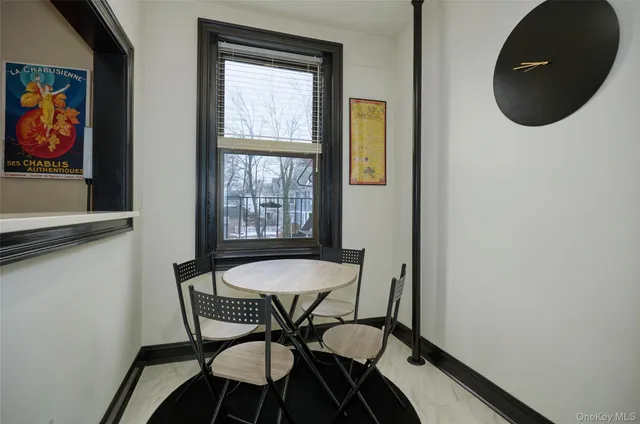 a dining room with furniture and window