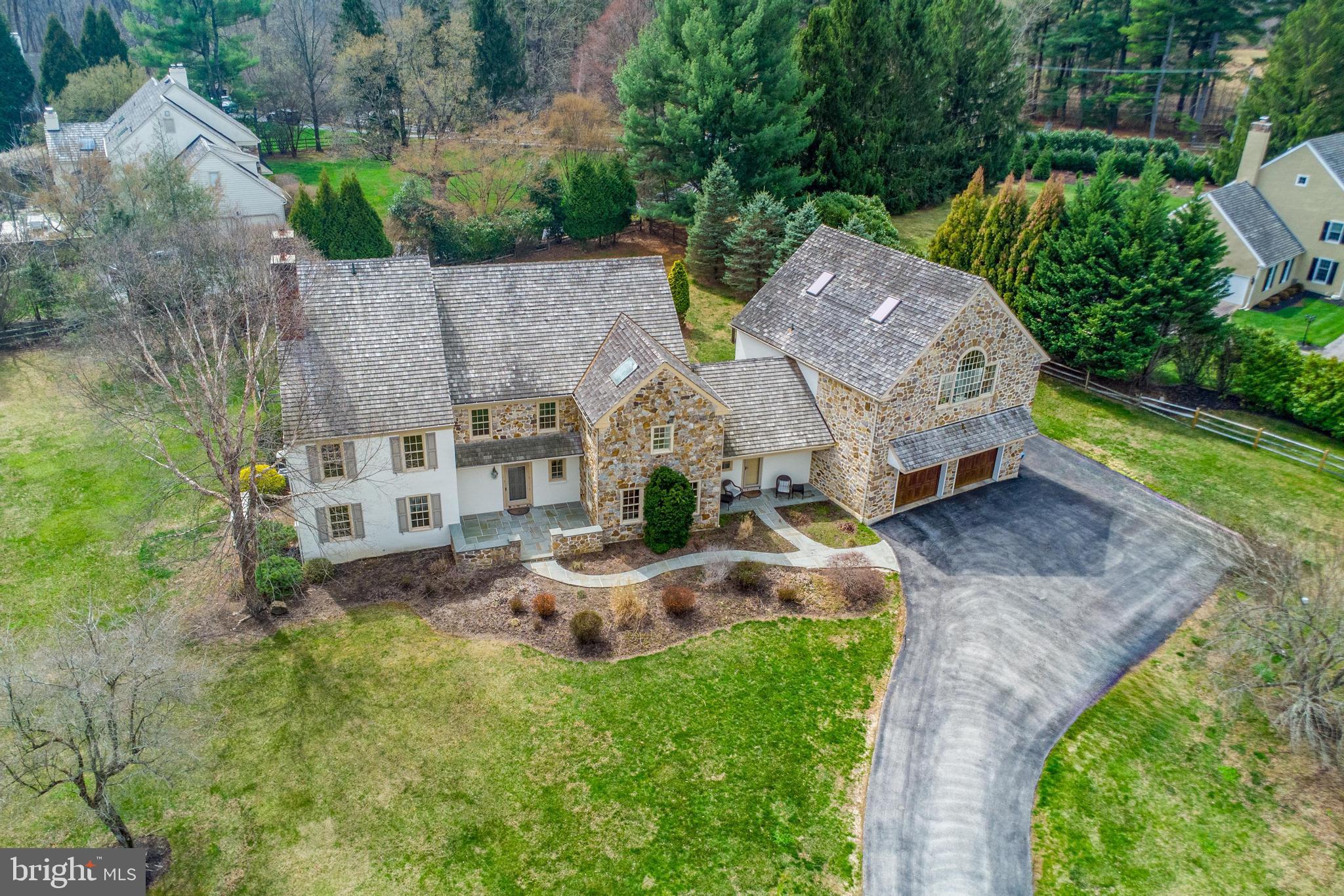 an aerial view of a house with garden space and street view