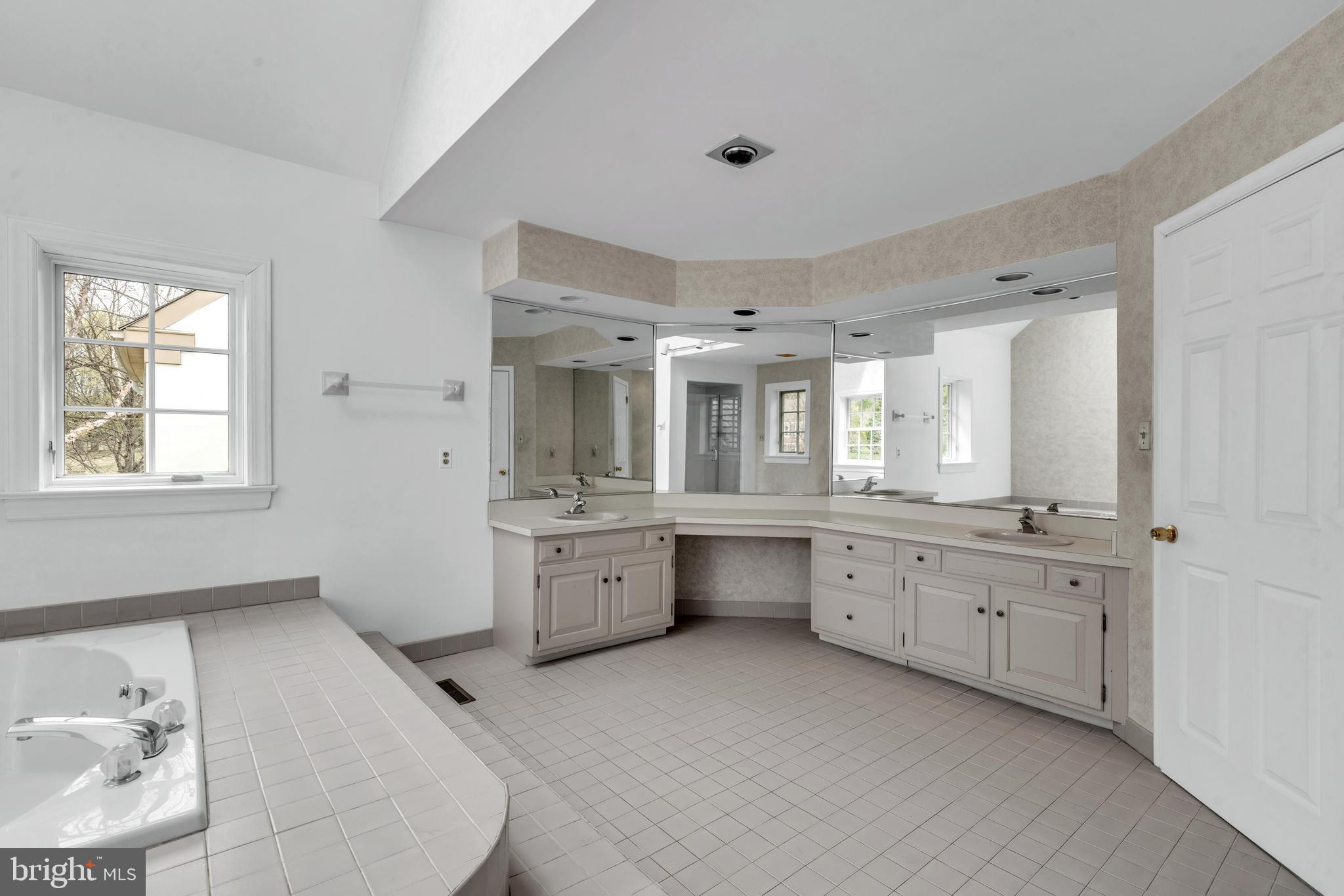 292 Church Road Devon, PA 19333 - Photo 11 of 21 a large white tub sitting in a en suite bathroom