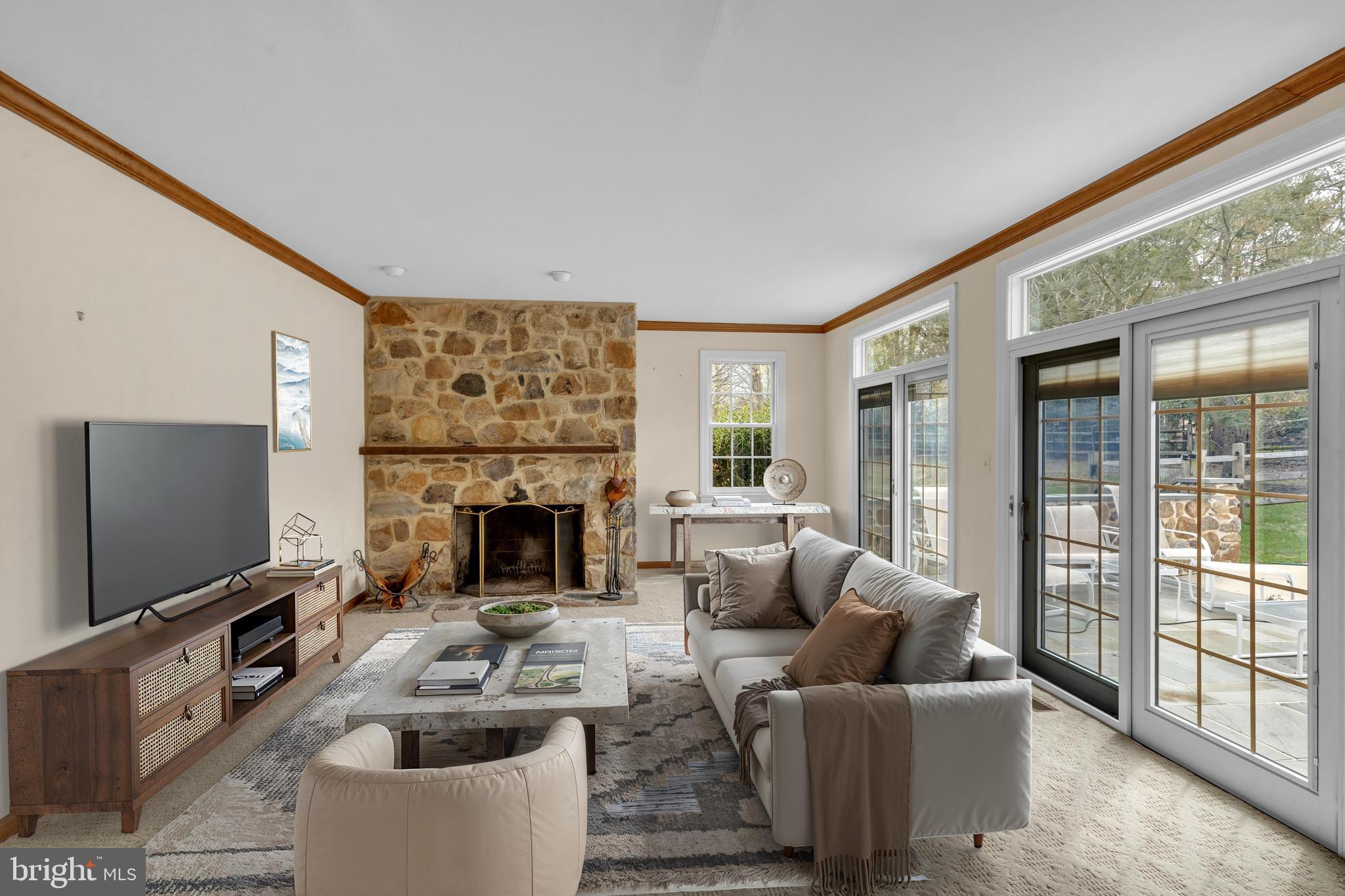 292 Church Road Devon, PA 19333 - Photo 4 of 21 a living room with furniture a flat screen tv and a fireplace