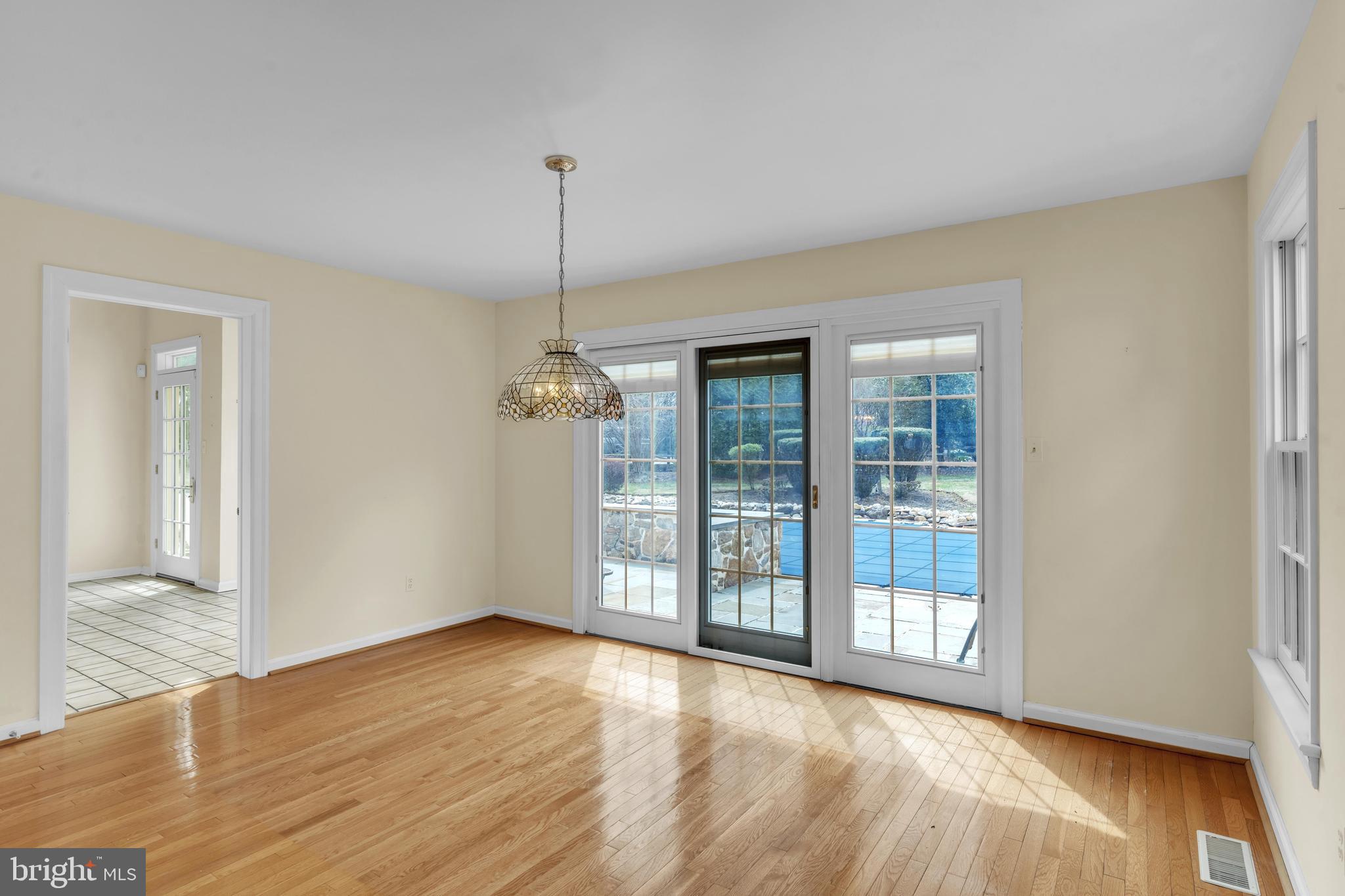 292 Church Road Devon, PA 19333 - Photo 7 of 21 a view of an empty room with window and wooden floor