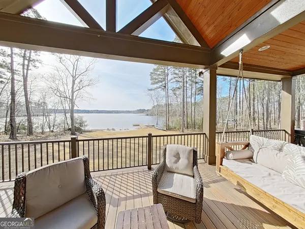 a balcony with furniture and wooden floor