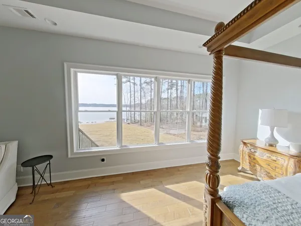 a bedroom with a bed and a mirror on the dresser