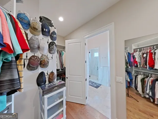 a view of walk in closet with clothes