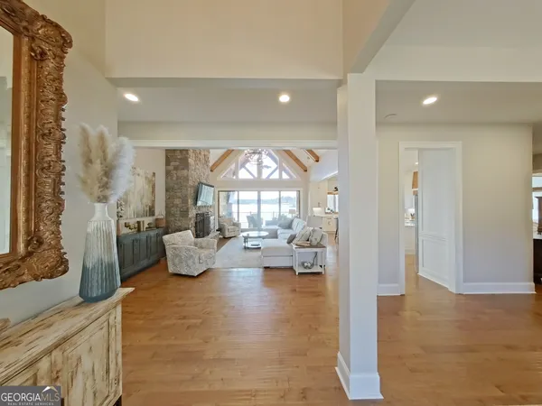 a living room with fireplace furniture and a large window