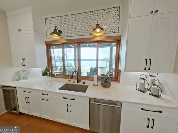 a kitchen with counter top space and living room