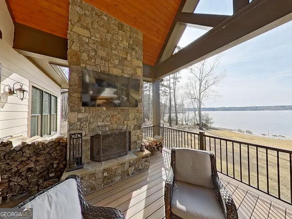a balcony with furniture and a fireplace