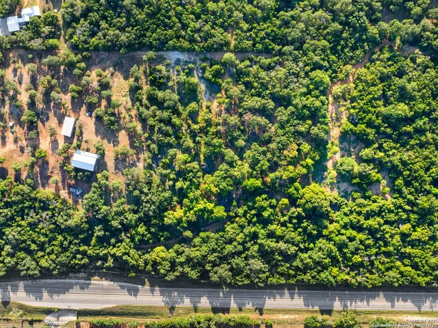 a view of a yard with wooden fence