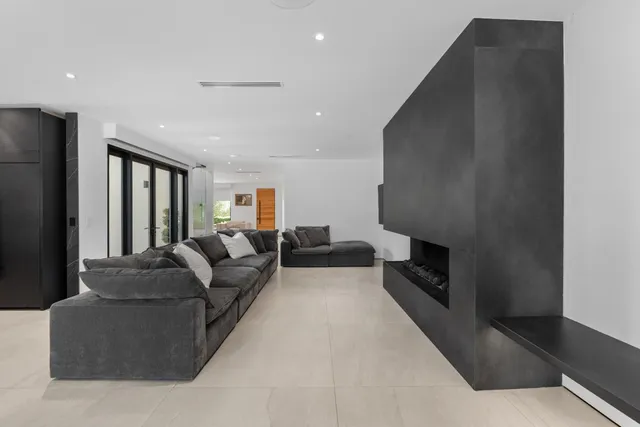 a living room with furniture and a mirror