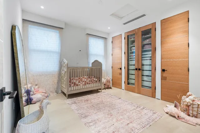 a spacious bedroom with a large bed and a large window