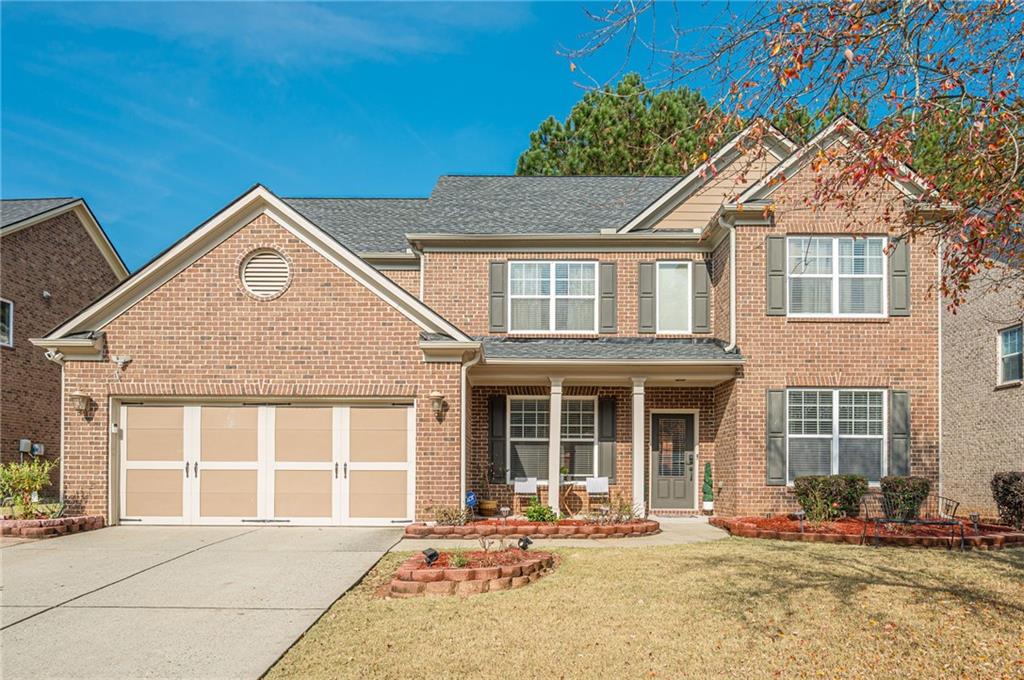 4890 Shiloh Crossing Way Cumming, GA 30040 - Photo 1 of 1 a front view of a house with a yard