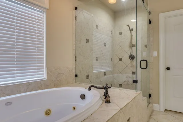 a bathroom with a bathtub and a shower