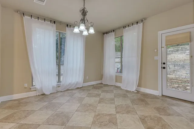 a kitchen with kitchen island granite countertop a refrigerator and a sink