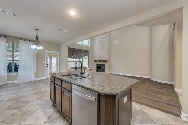 a kitchen with granite countertop a sink and cabinets