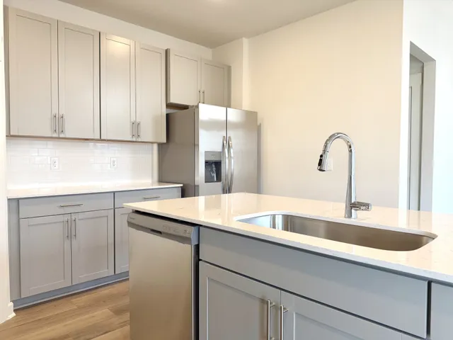 a kitchen with a refrigerator a microwave and cabinets