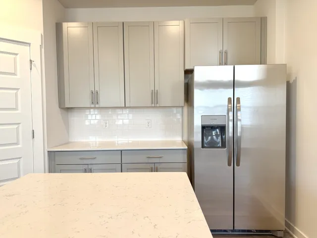 a view of a room with wooden floor and door