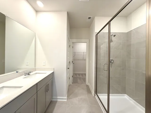 a bathroom with a double vanity sink and a mirror