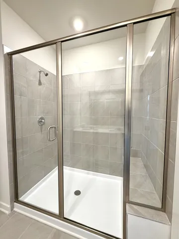 a white toilet sitting next to a white wall