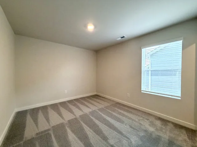 a view of an empty room and a window