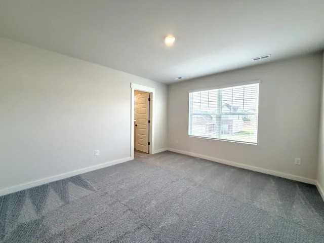 an empty room with closet and bathroom