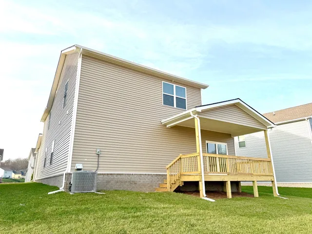 a backyard of a house with table and chairs