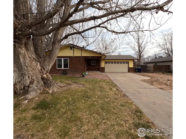 a front view of house with yard covered in snow