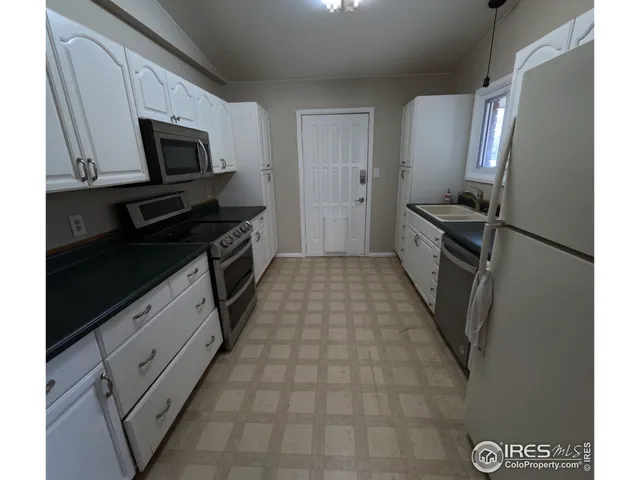 a kitchen with a sink stainless steel appliances and cabinets