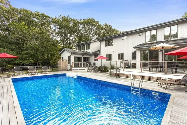 a view of house with yard outdoor seating and lake view