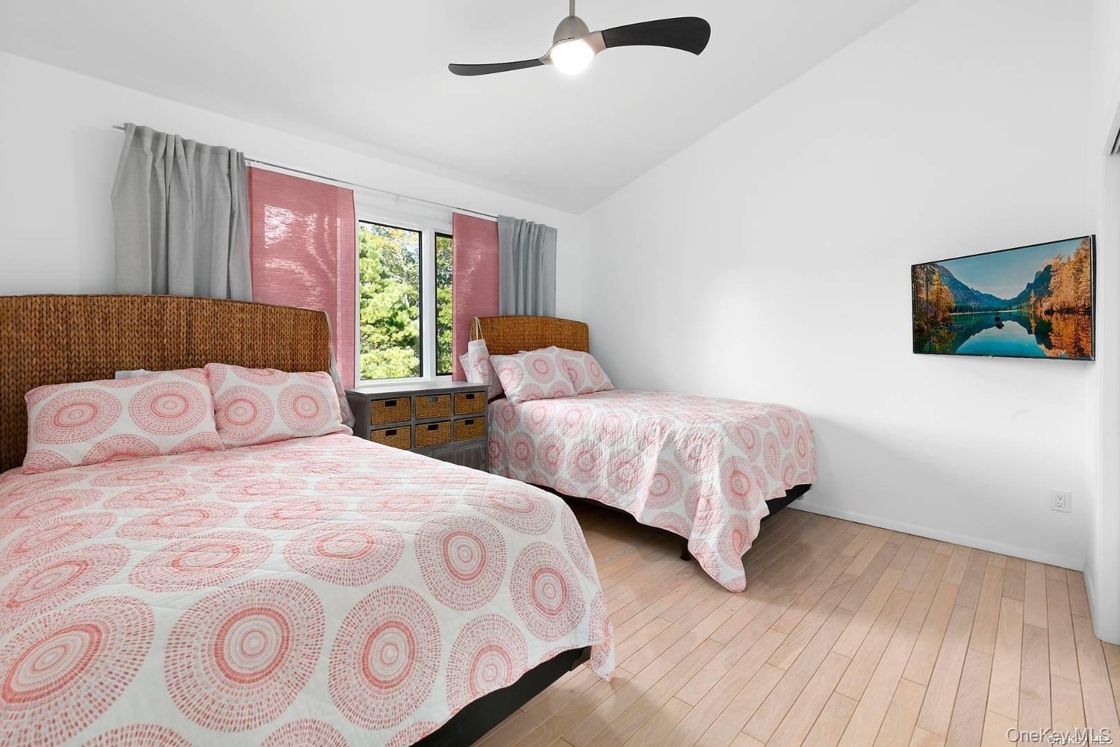 7 Harbor Road Hampton Bays, NY 11946 - Photo 12 of 22 a bedroom with two beds and a large window