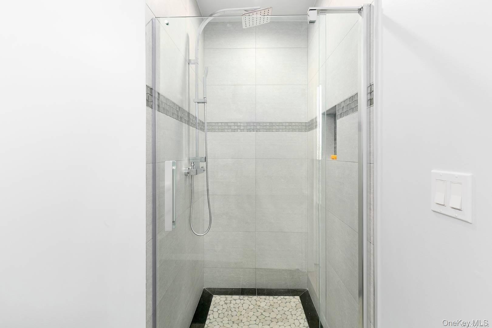 7 Harbor Road Hampton Bays, NY 11946 - Photo 13 of 22 a bathroom with a glass shower door