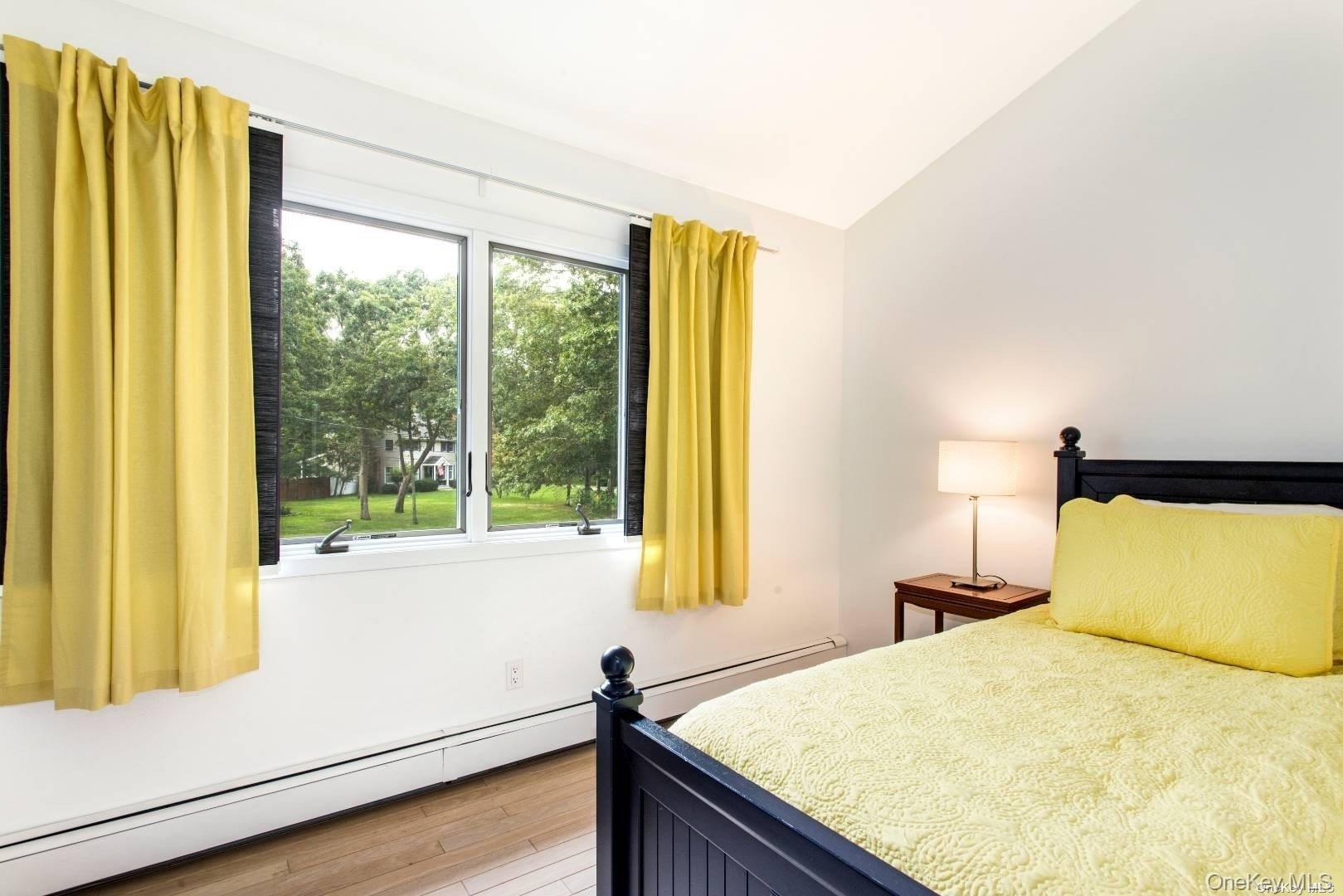 7 Harbor Road Hampton Bays, NY 11946 - Photo 16 of 22 a bedroom with a bed and a large window