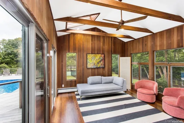 a spacious bedroom with a bed and large windows