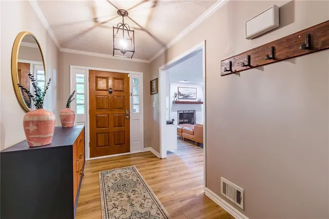 a view of a hallway to a livingroom with furniture