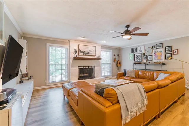 a bed room with a bed television and a window