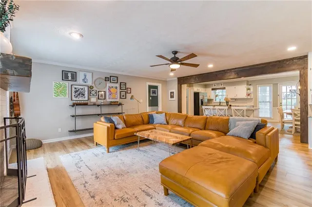 a living room with furniture and wooden floor