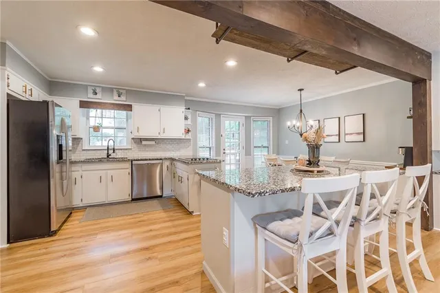 a kitchen with cabinets a sink and appliances