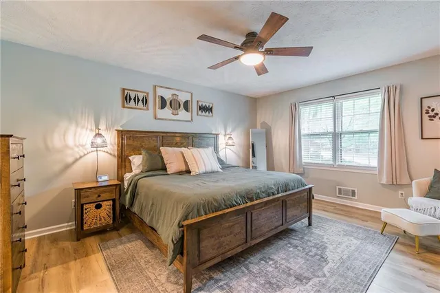 a bed sitting in a bedroom next to a window